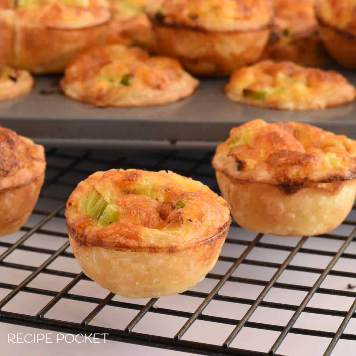 Mini quiche on a wire rack.