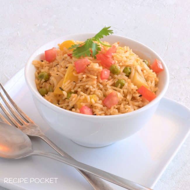 Indian spicy rice in a white bowl.
