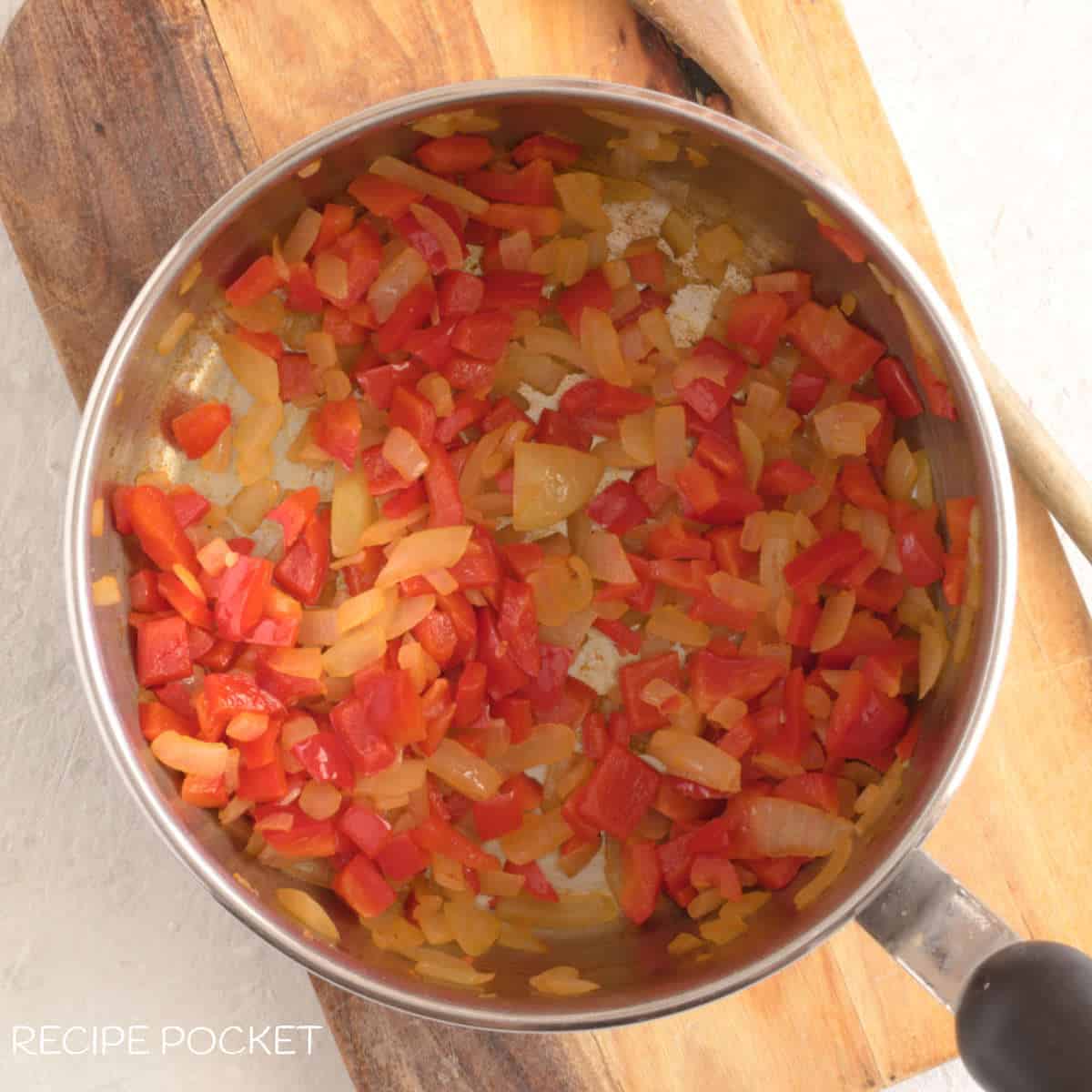 Sauted onions, and capsicum in a pot.