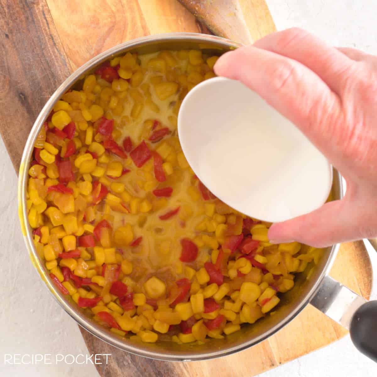 Corn-starch added to the relish mixture in the saucepan.