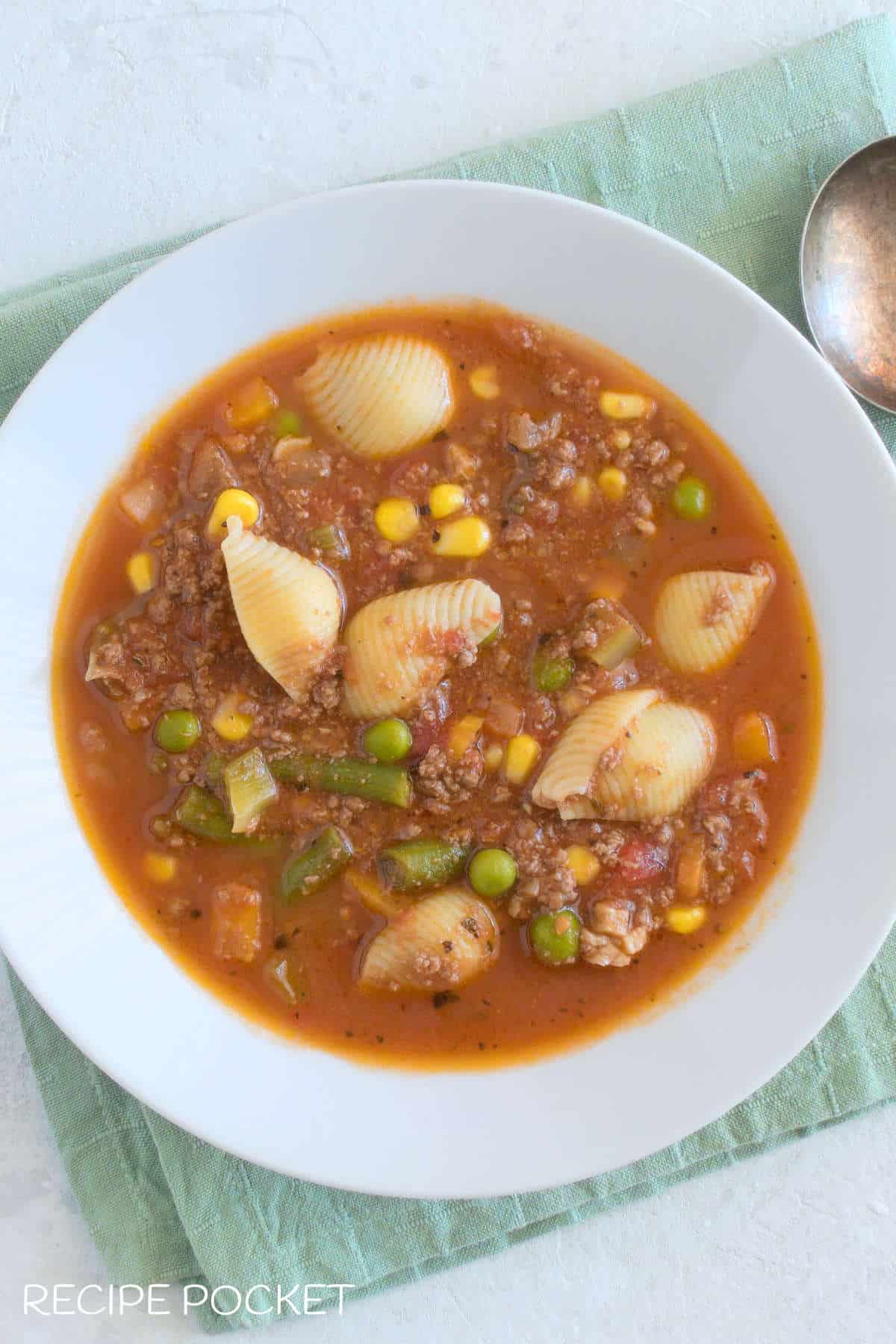 Top down photo of soup in a white bowl.