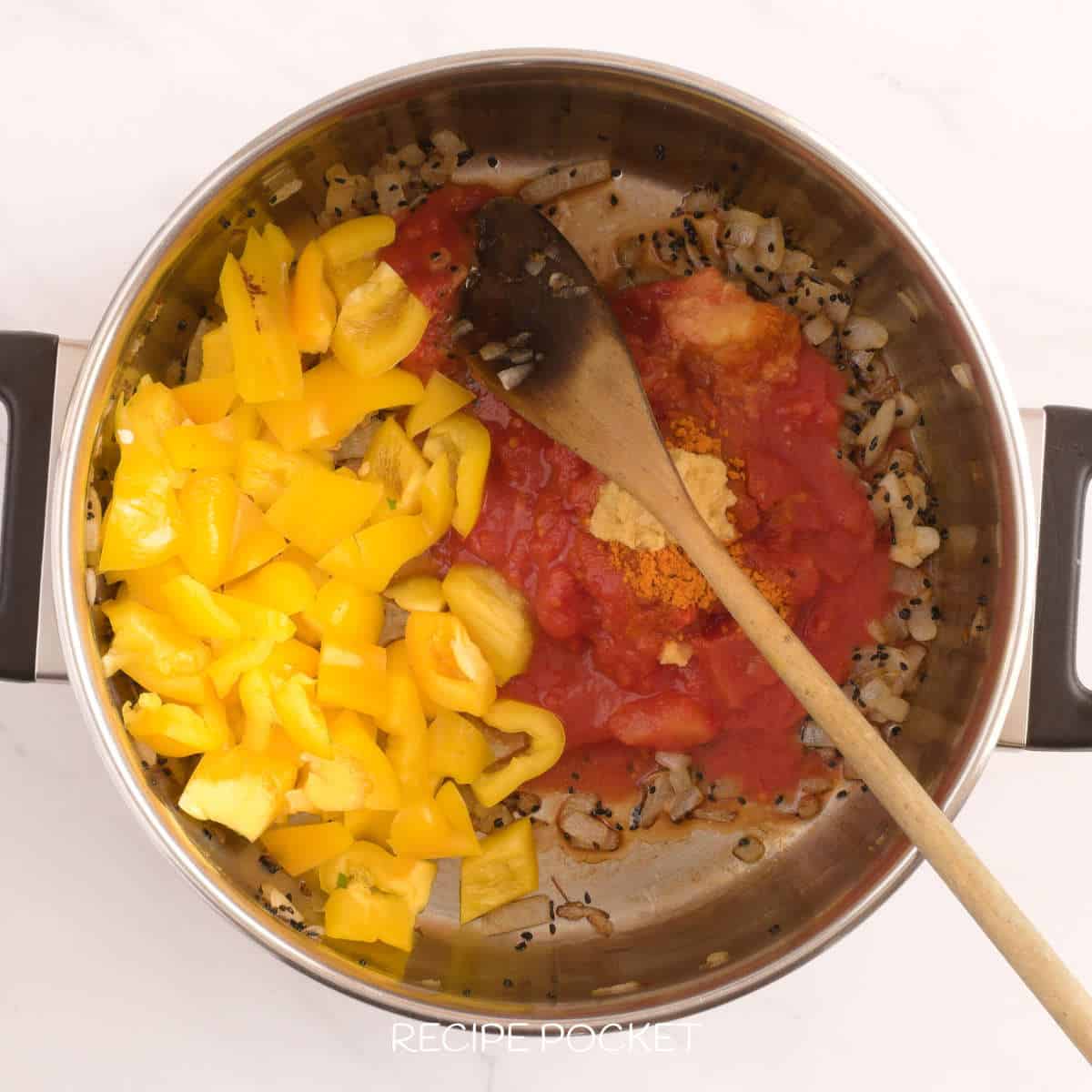 Capsicum and tomato with onion in a pot.