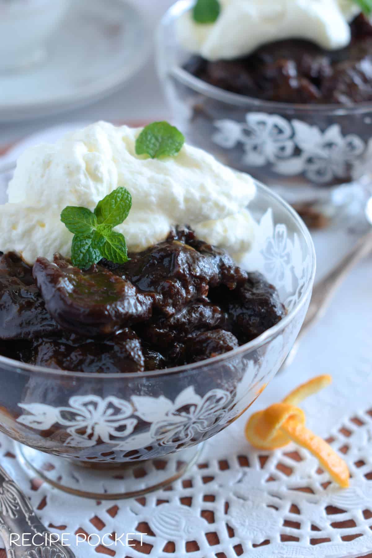 A close up of prunes and cream dessert.