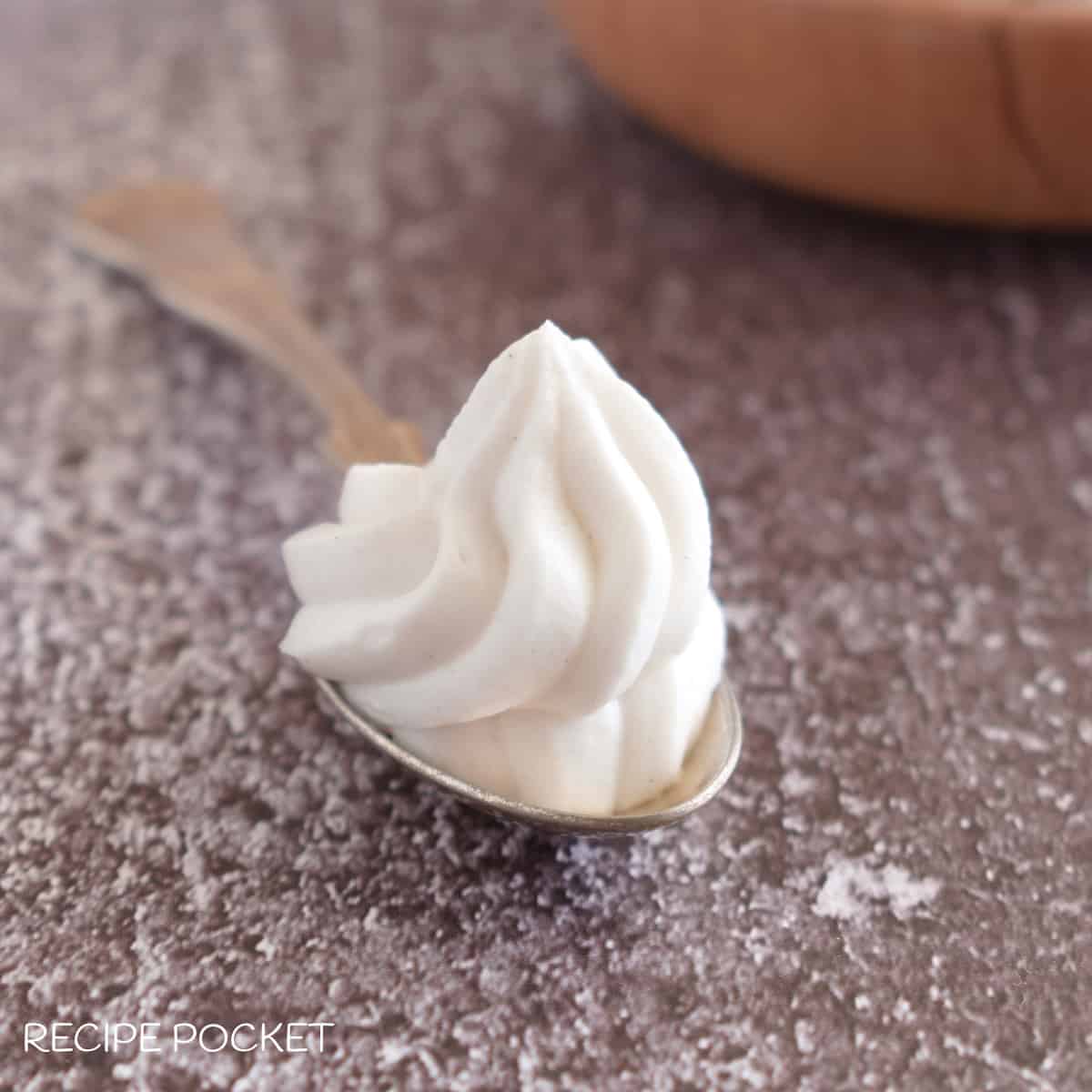 A vegan mascarpone cheese substitute piped onto a spoon.