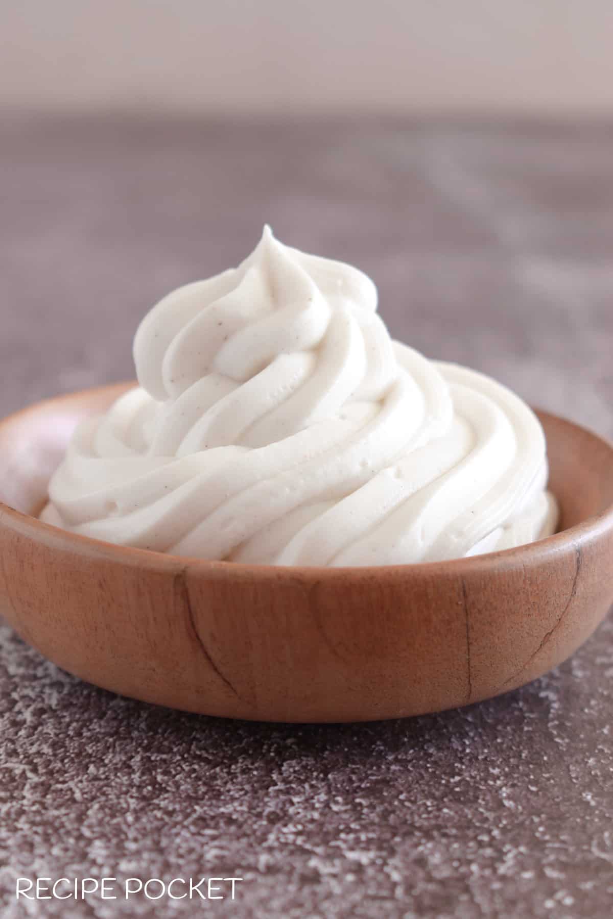 Homemade dairy free mascarpone cheese substitute in a small wooden bowl.