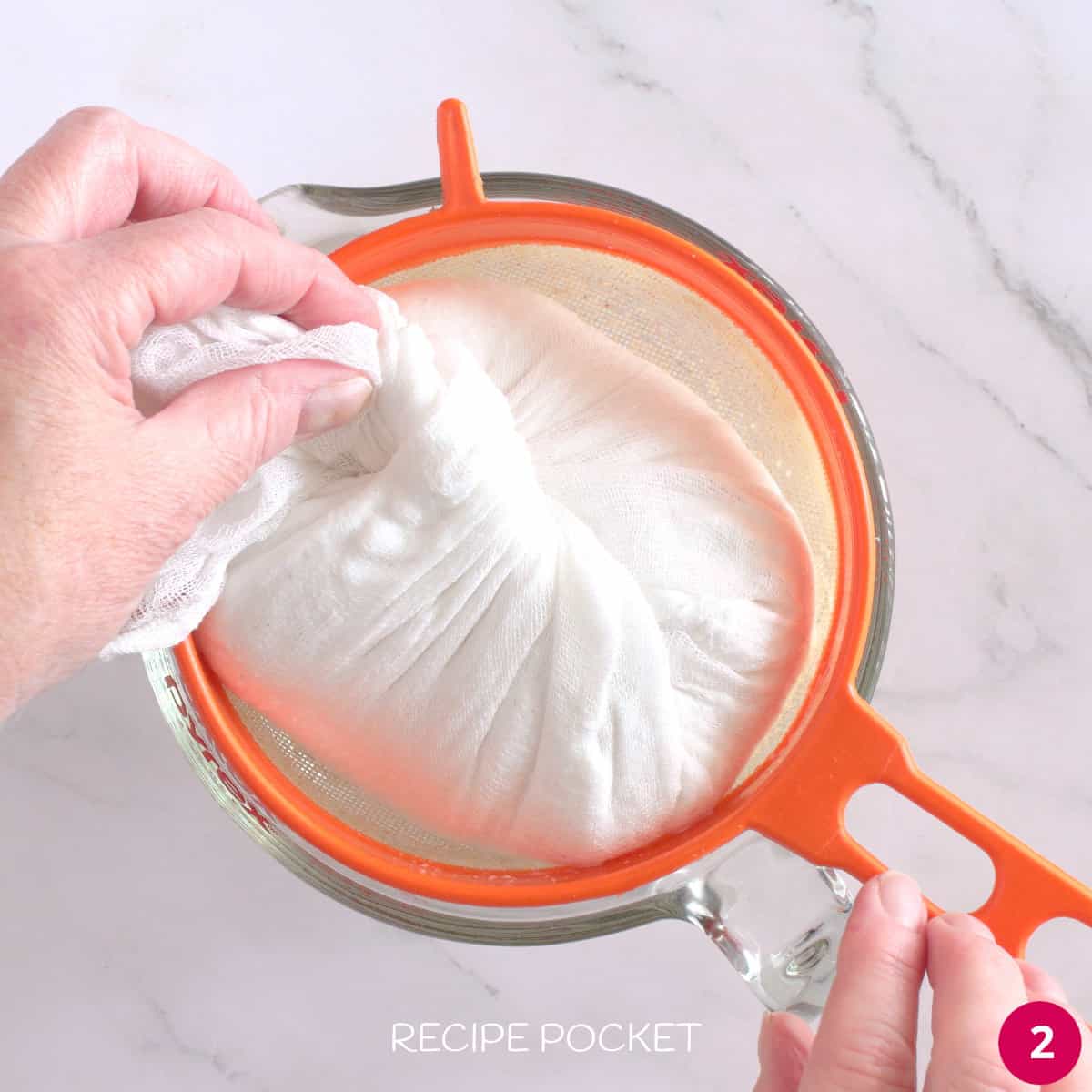 Muslin cloth with yogurt inside set over a strainer for draining.