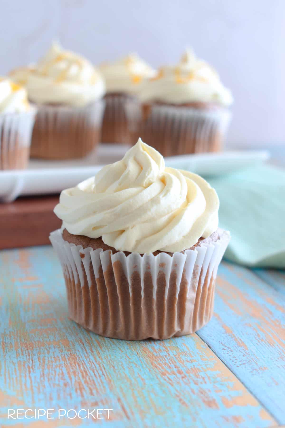 A closeup of a cupcake with cupcakes in the background.