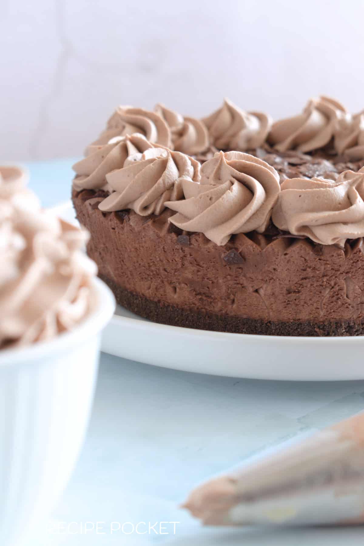 Chocolate whipped cream decorations on a mousse cake.