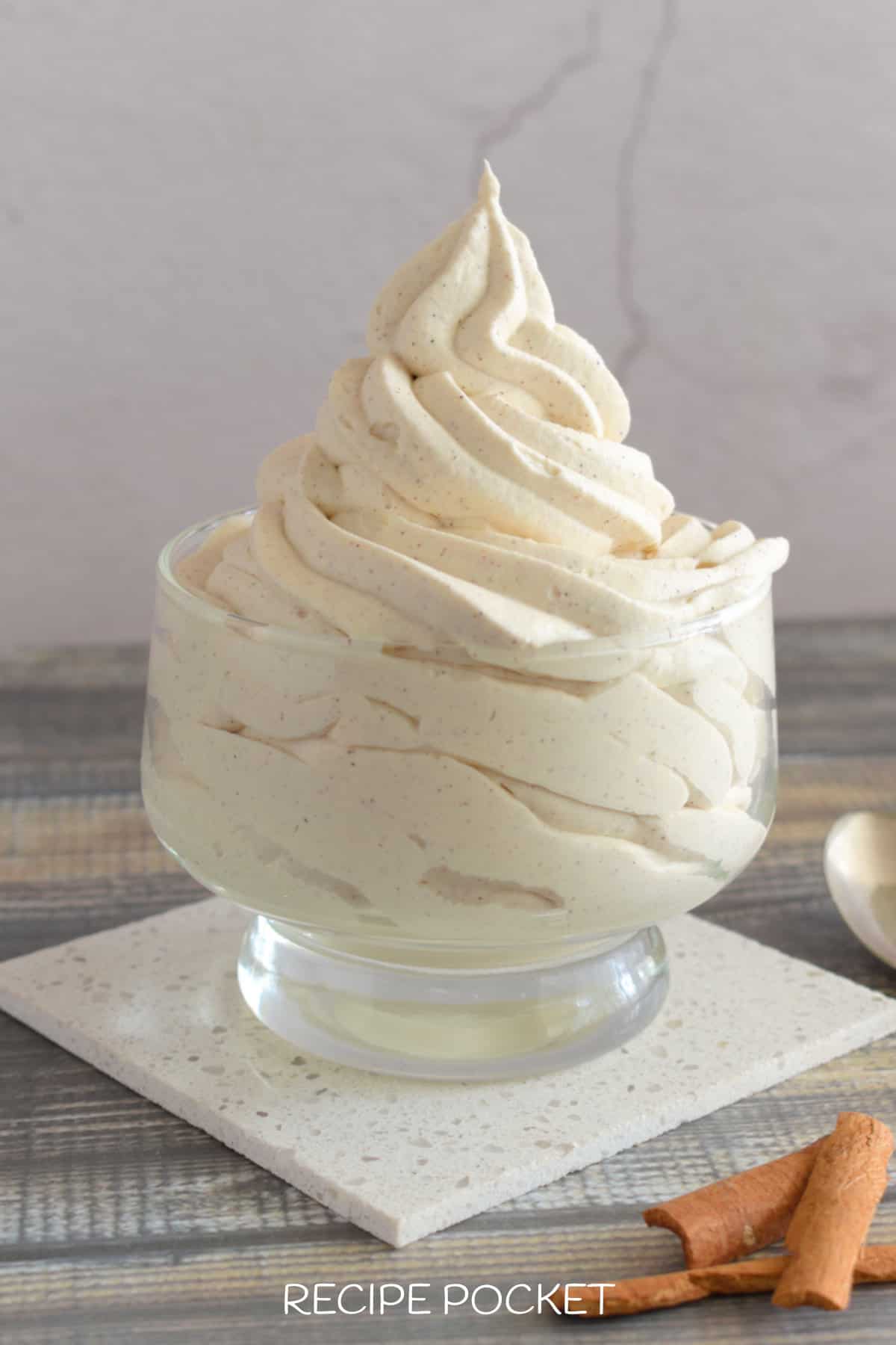 Whipped cream piped into a glass bowl.