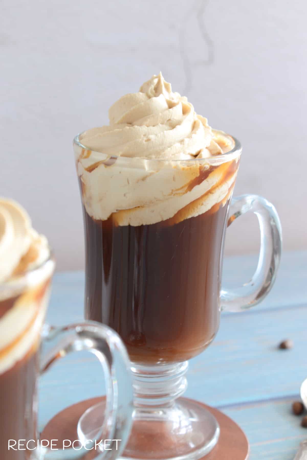Whipped cream in a glass with coffee.