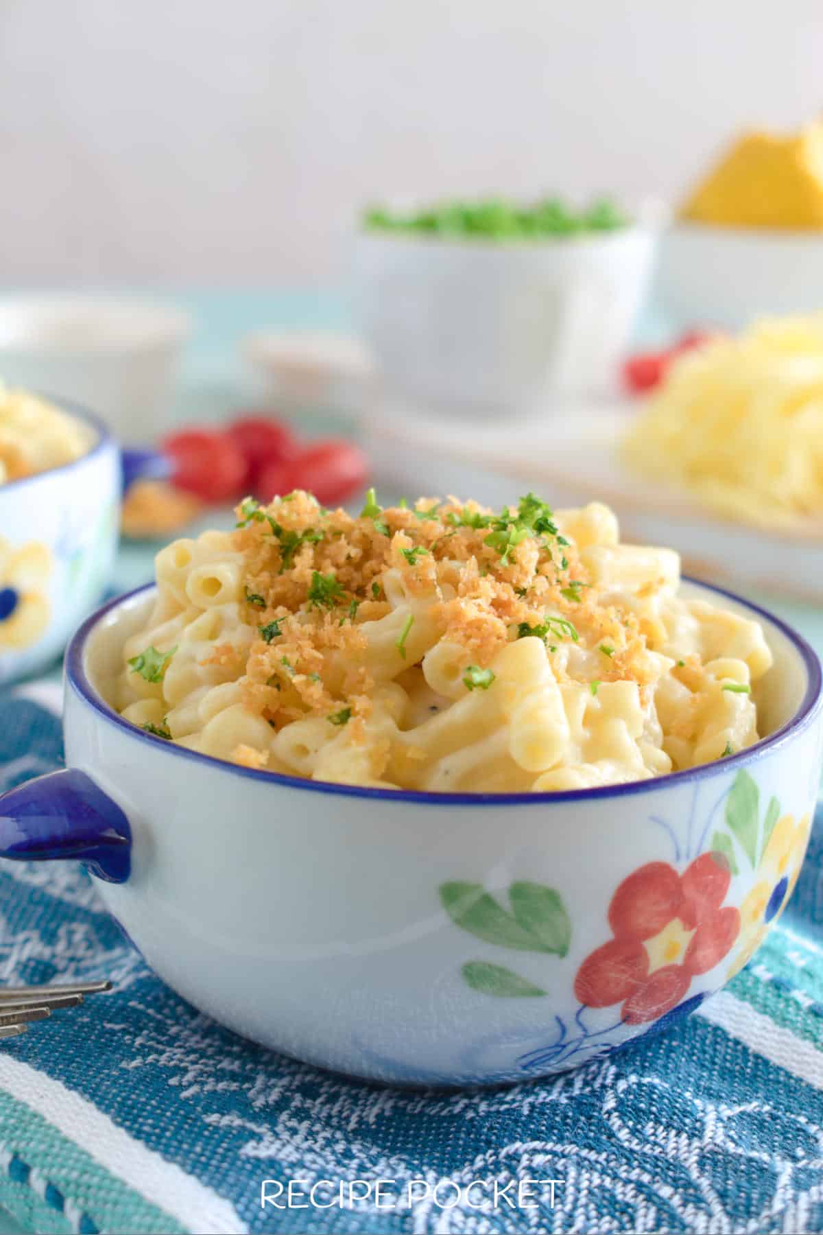 Pasta dinner with vegetable side dishes in the background.