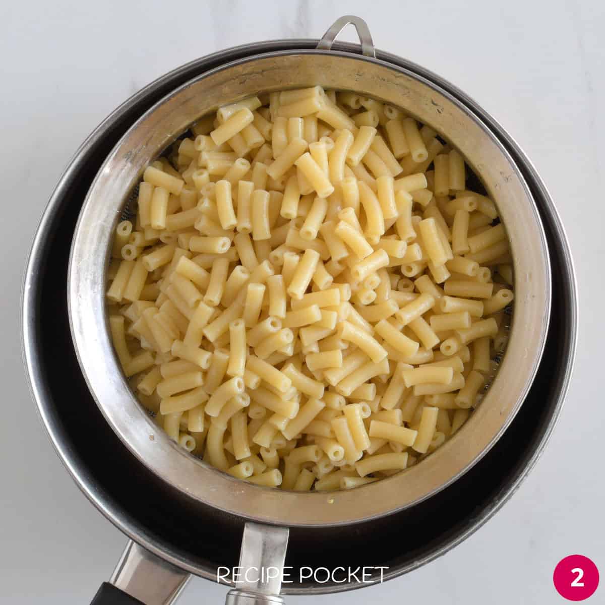 Drained cooked pasta in sieve.