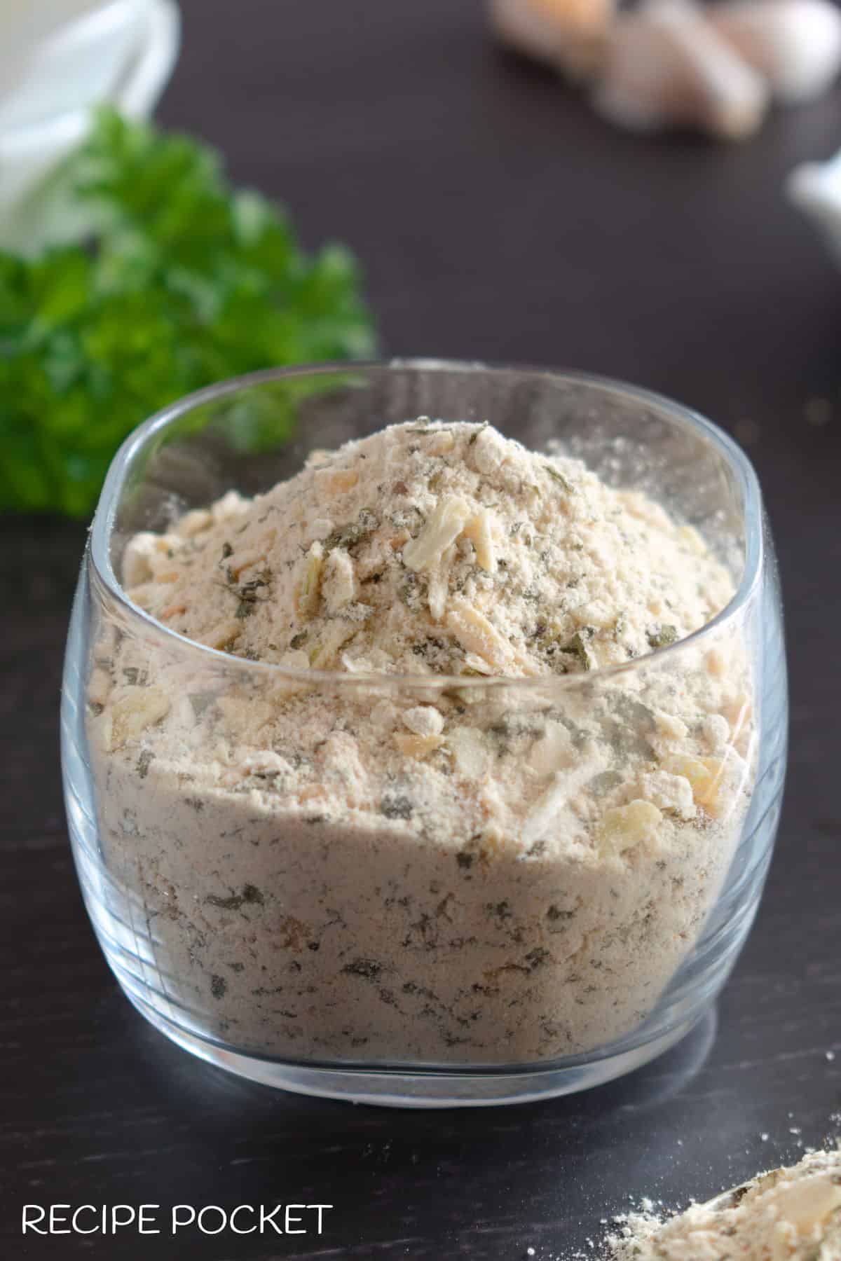 A glass bowl with onion soup powder.