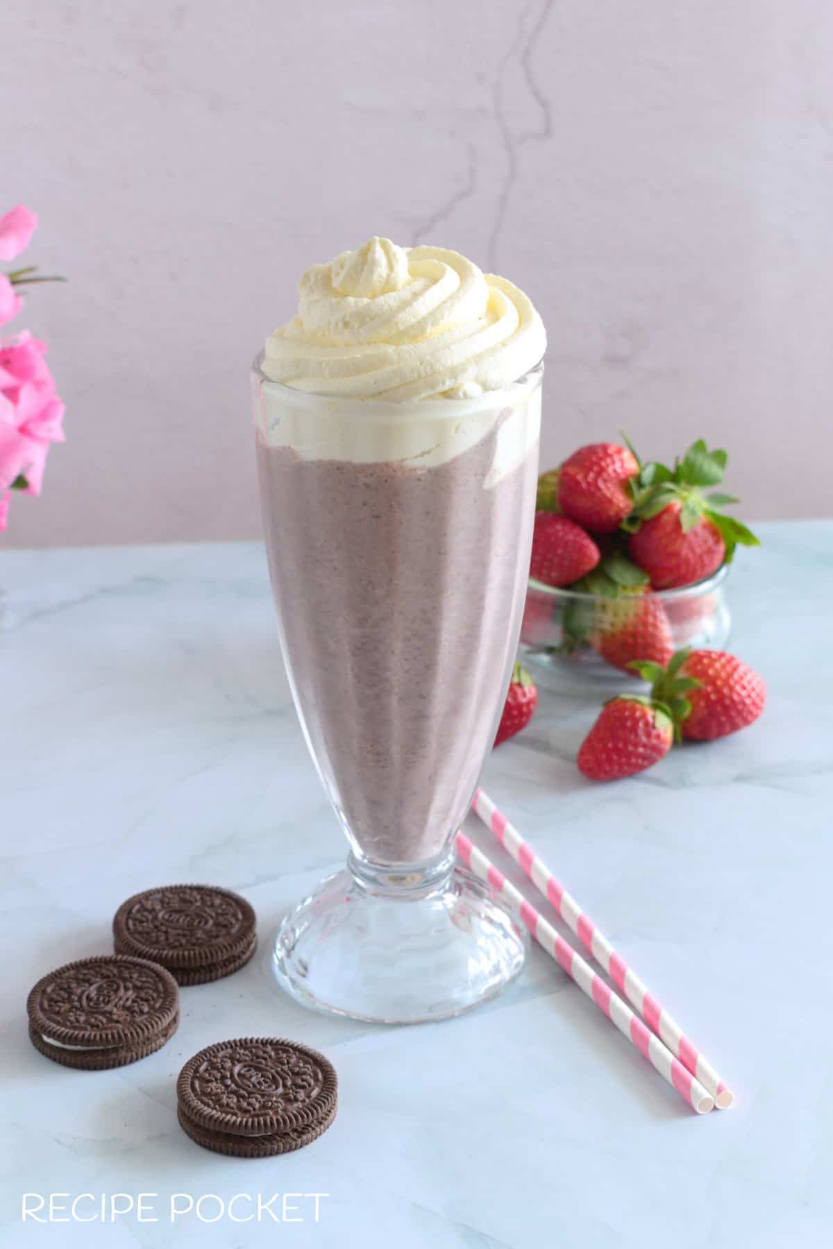 Milkshake in a glass with whipped cream.