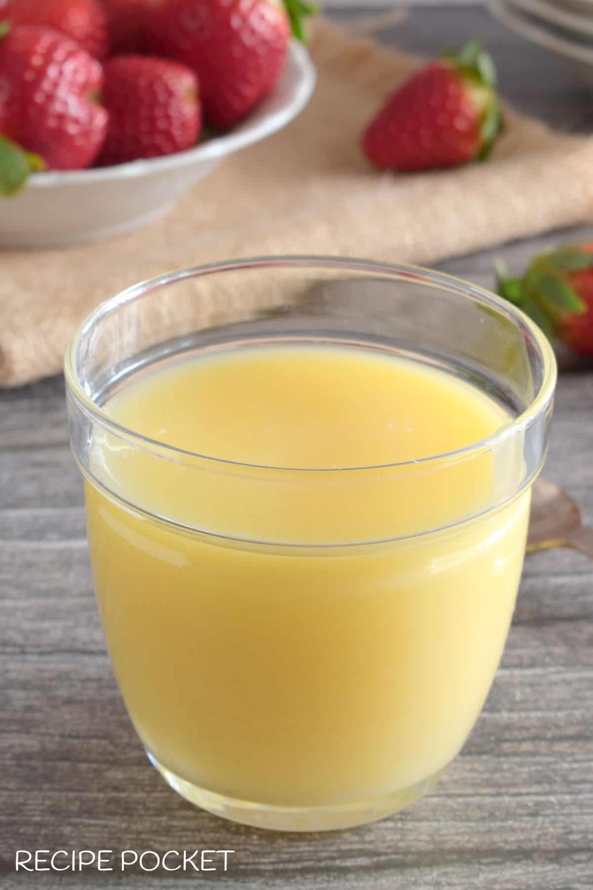 A container of white chocolate sauce.