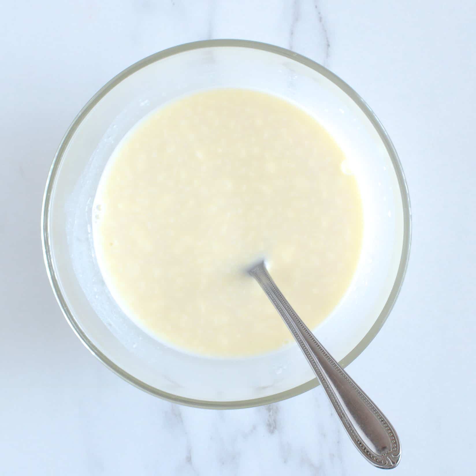 Milk and yogurt in a mixing bowl.
