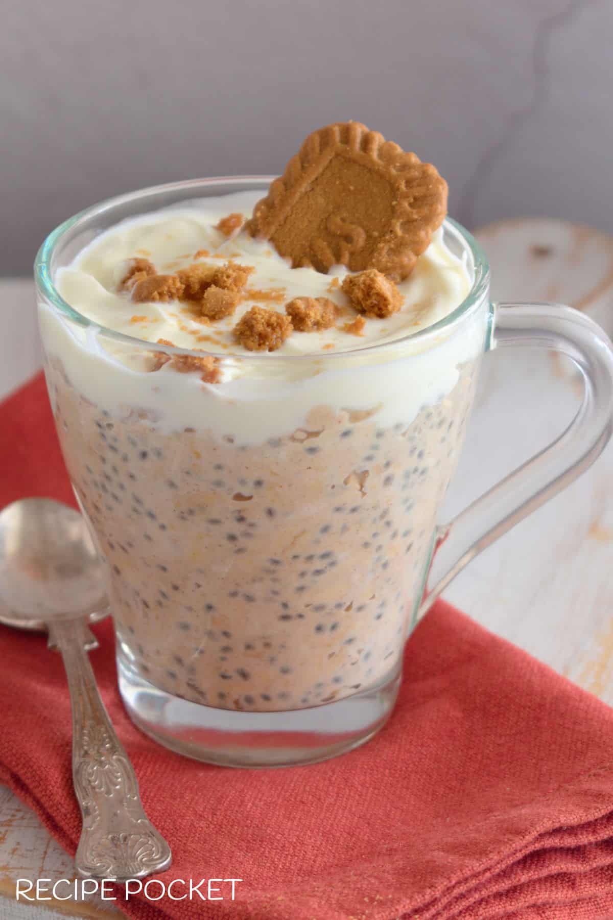 Biscoff overnight oats served in a glass mug.