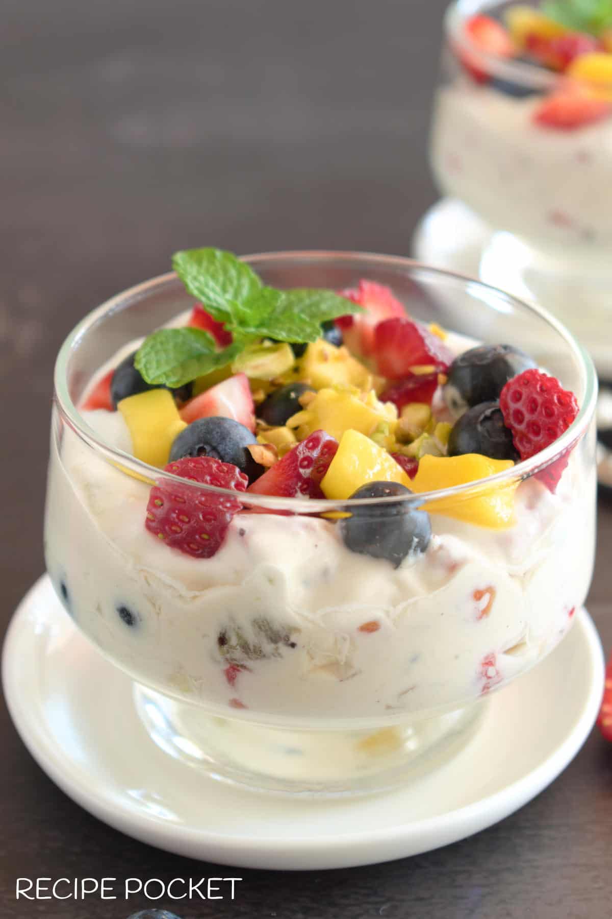 Cream dessert with mint leaf garnish.