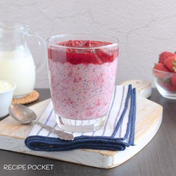 Raspberry overnight oats on a blue and white napkin.