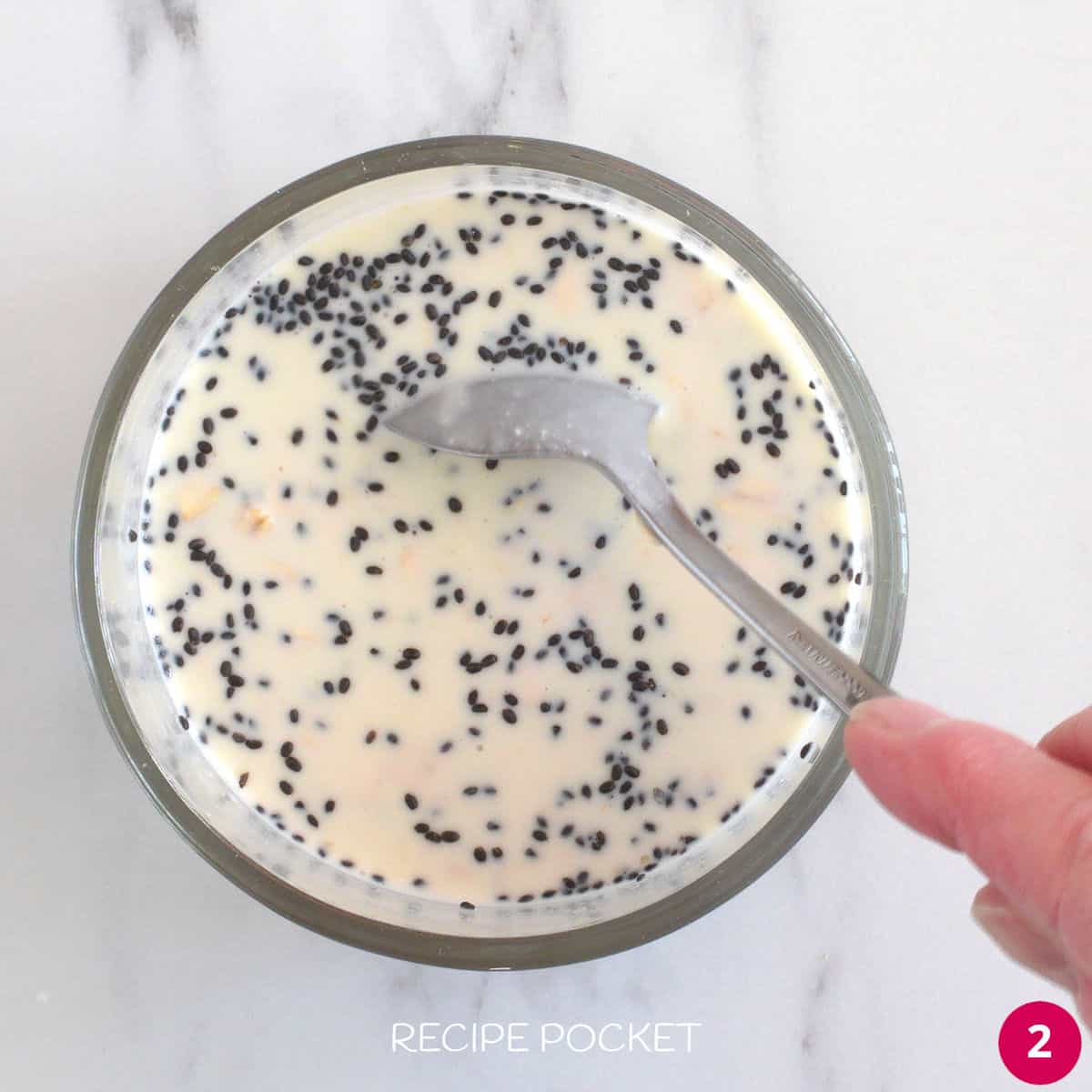 Oats and basil seeds with milk and yogurt in a bowl.