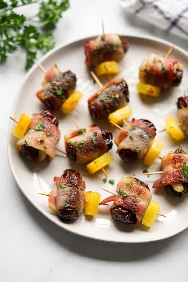 Dates wrapped in bacon with pineapple.