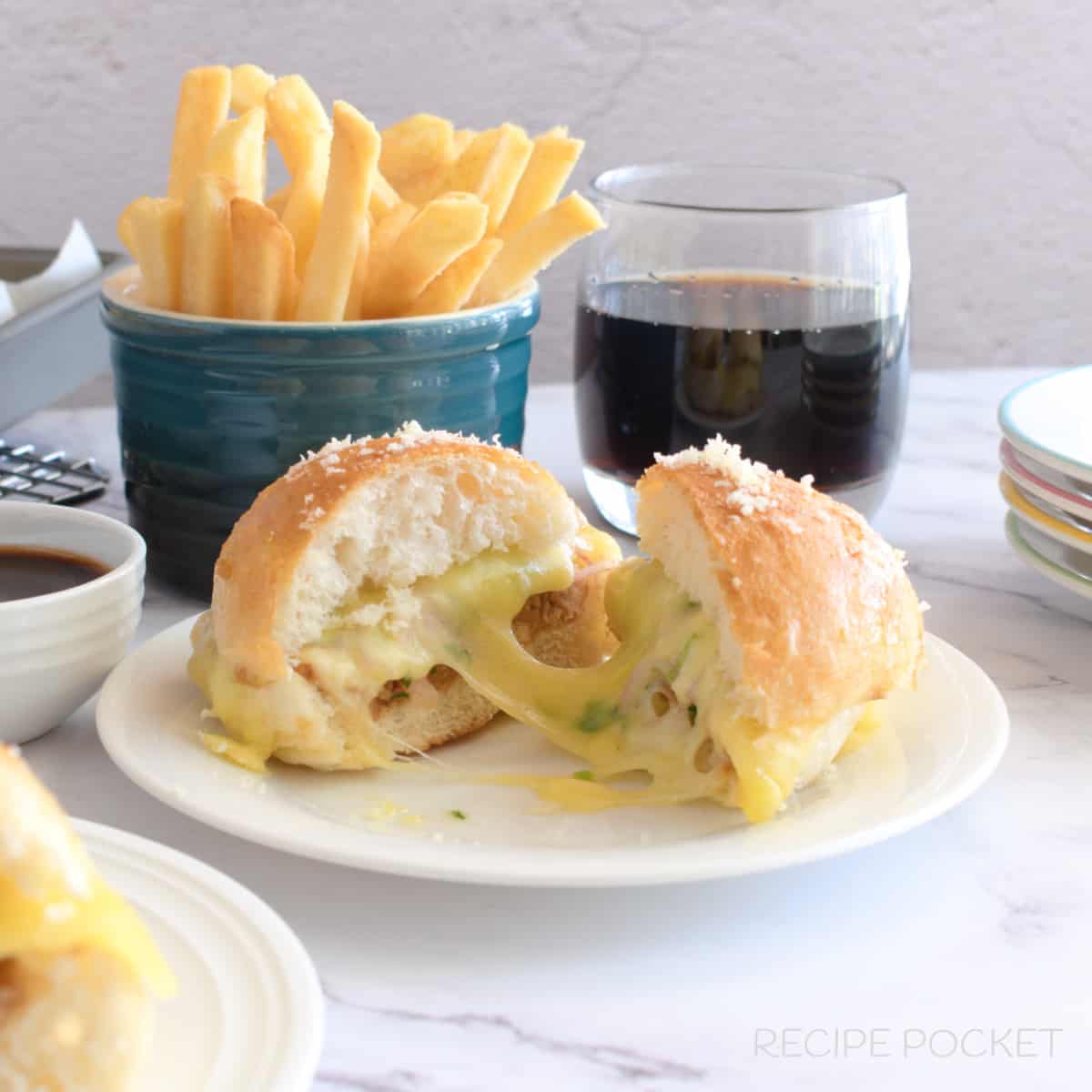 A cheese bbq chicken slider on a white plate.