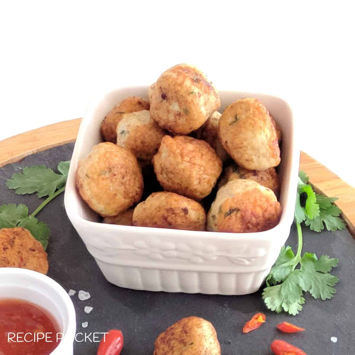 Minced chicken meatballs in a white serving dish.