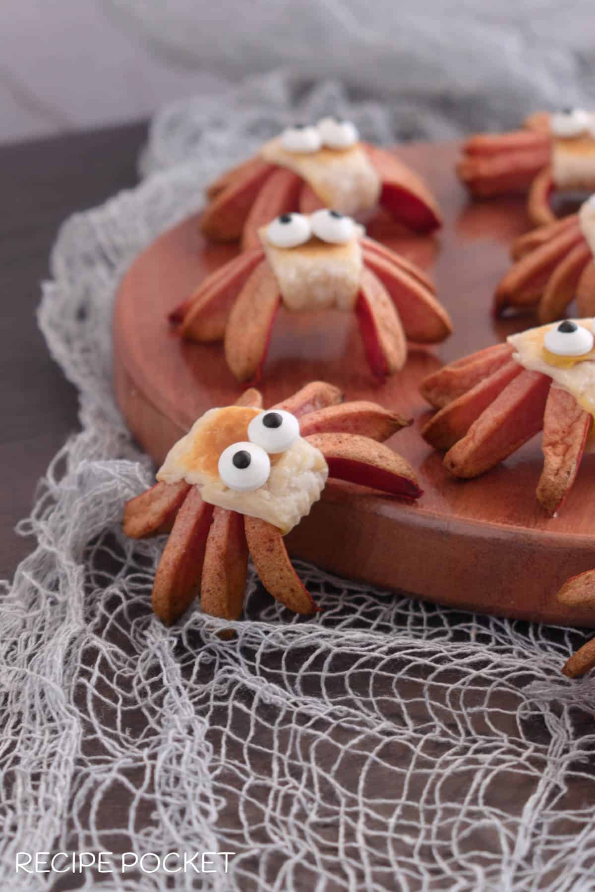 Spider hot dogs on a wooden board.