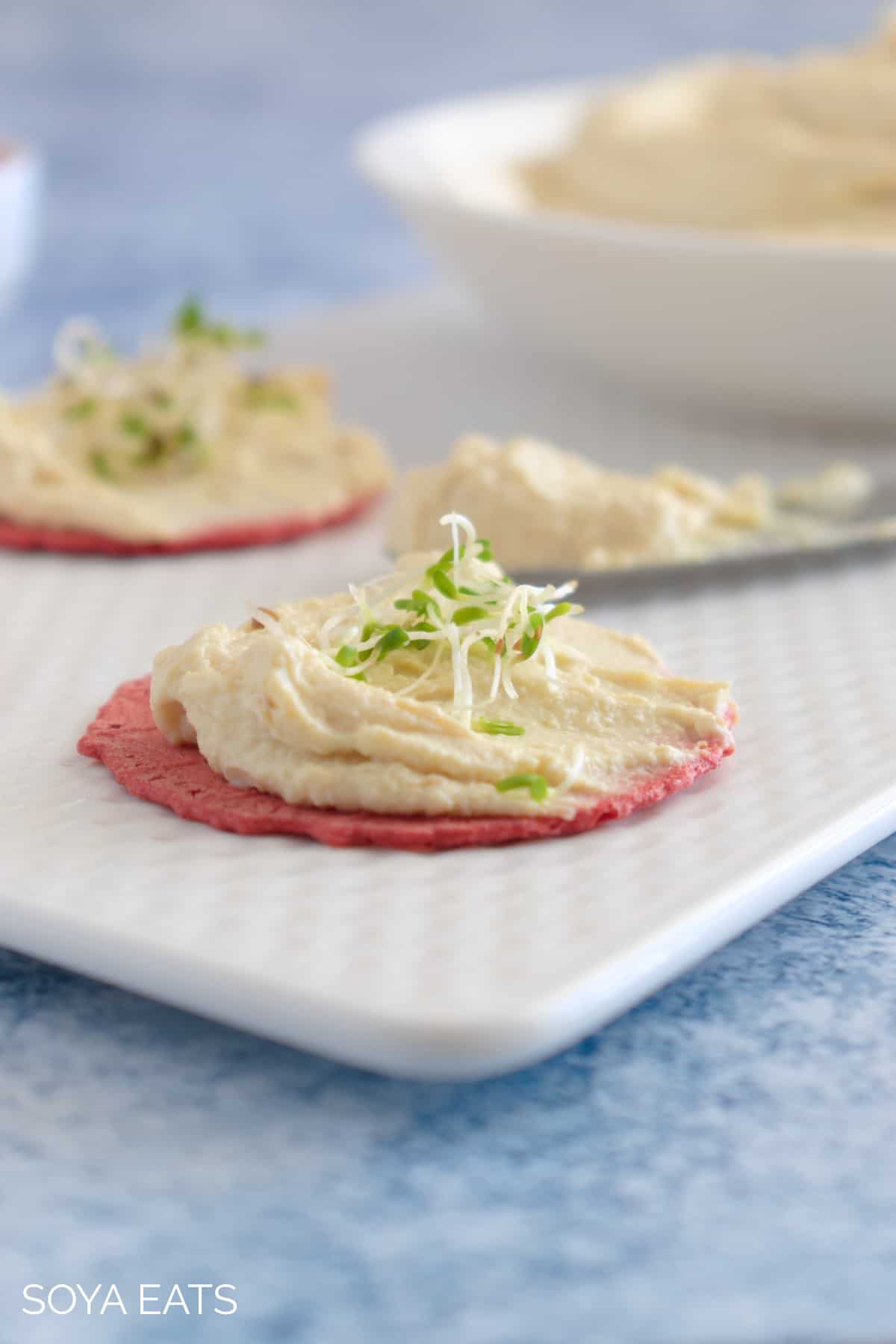 Tofu cream cheese on a beetroot cracker.