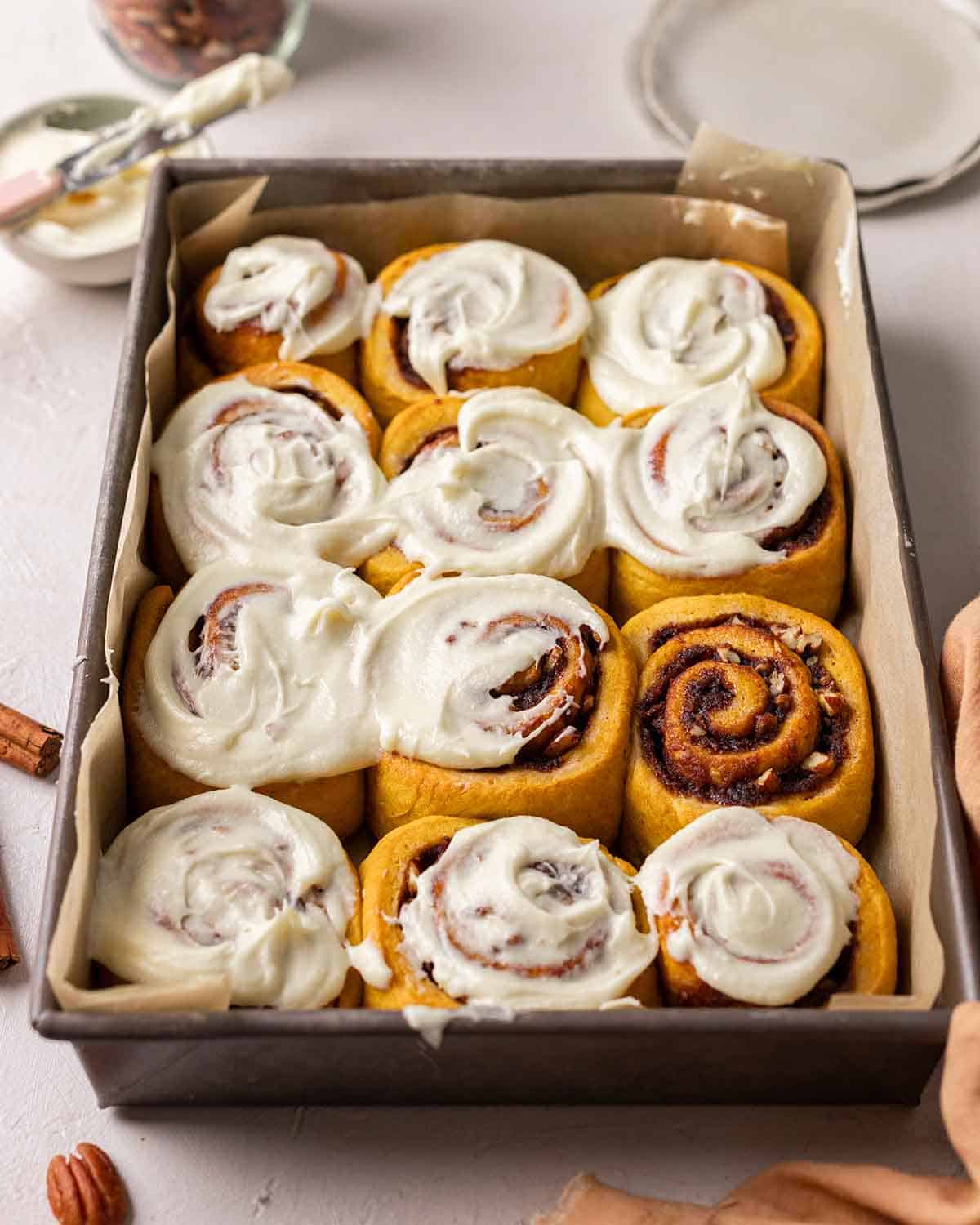 Vegan cinnamon rolls in a baking tin.