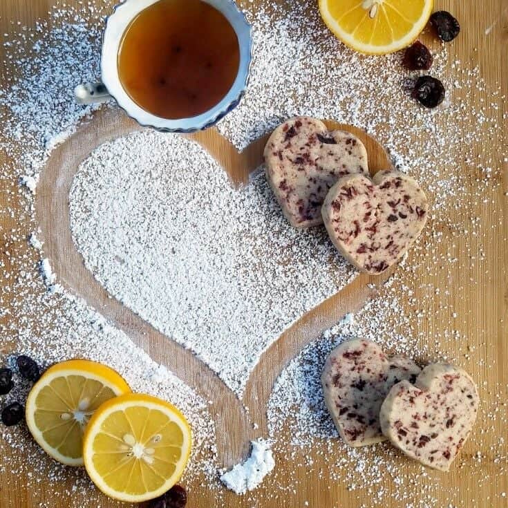 Cranberry shortbread cookies on a floured surface.