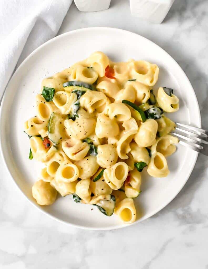 Veggie mac and cheese on a white plate.