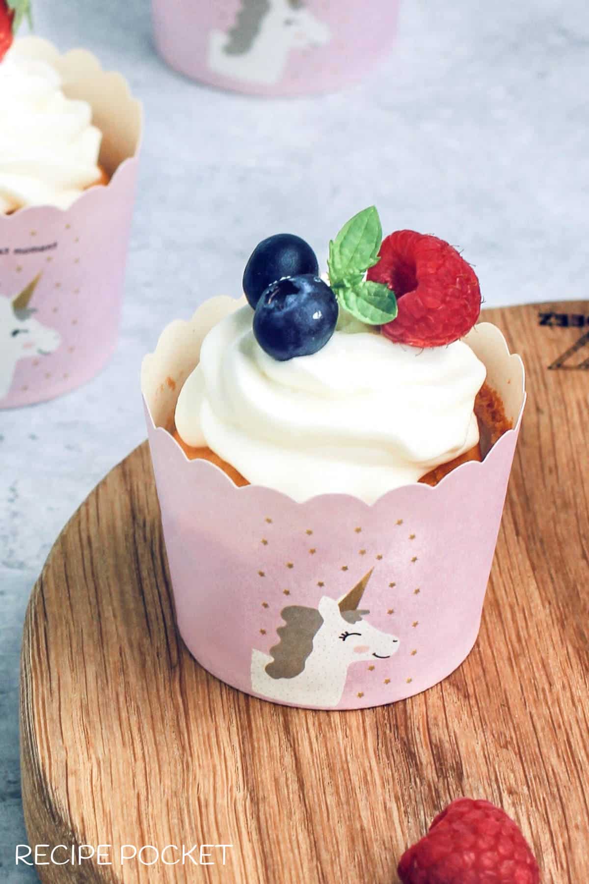 Image of a cup cake on a board for a blog post on baking equipment for beginners.