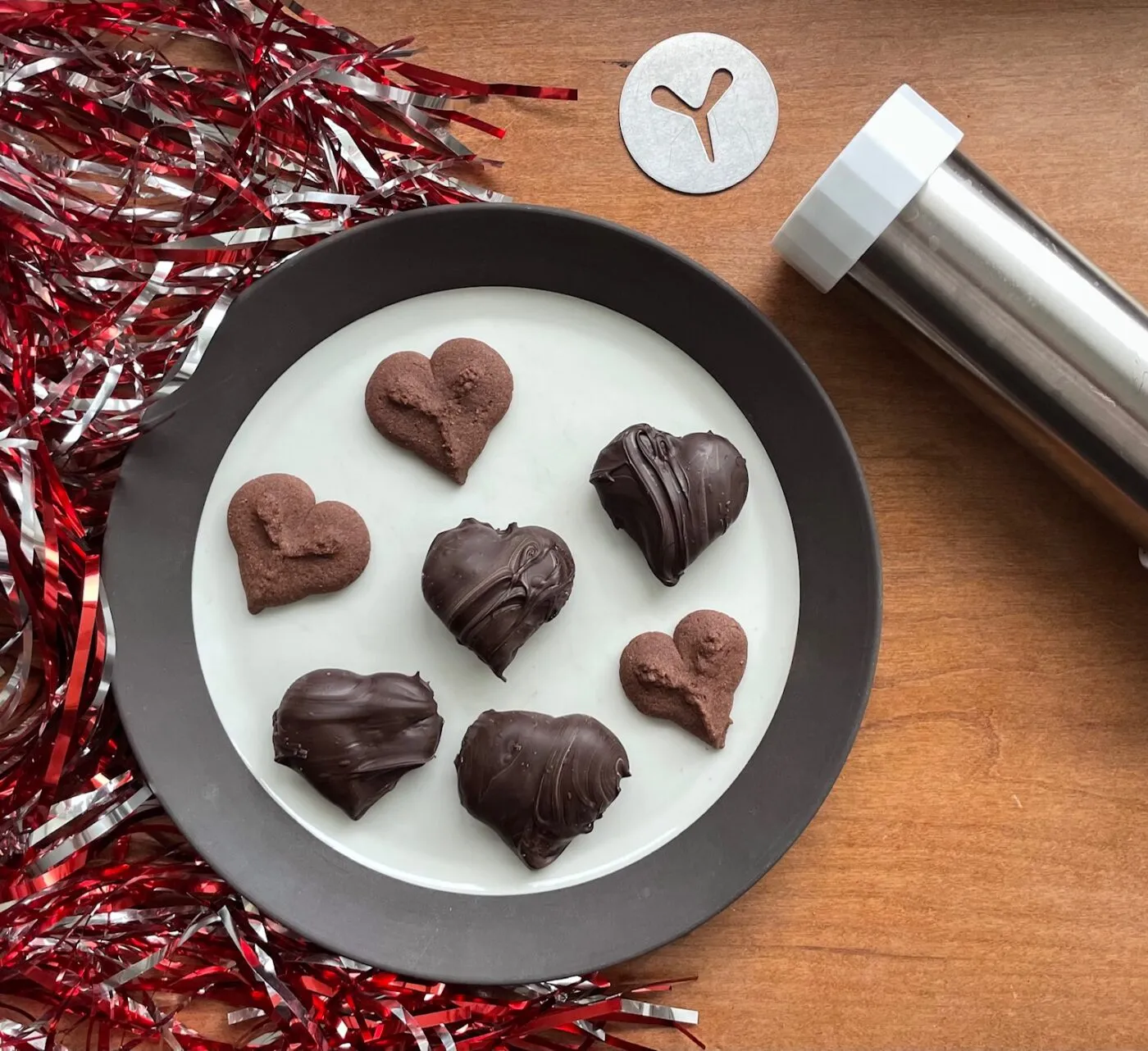 Small heart cookies coated in chocolate.
