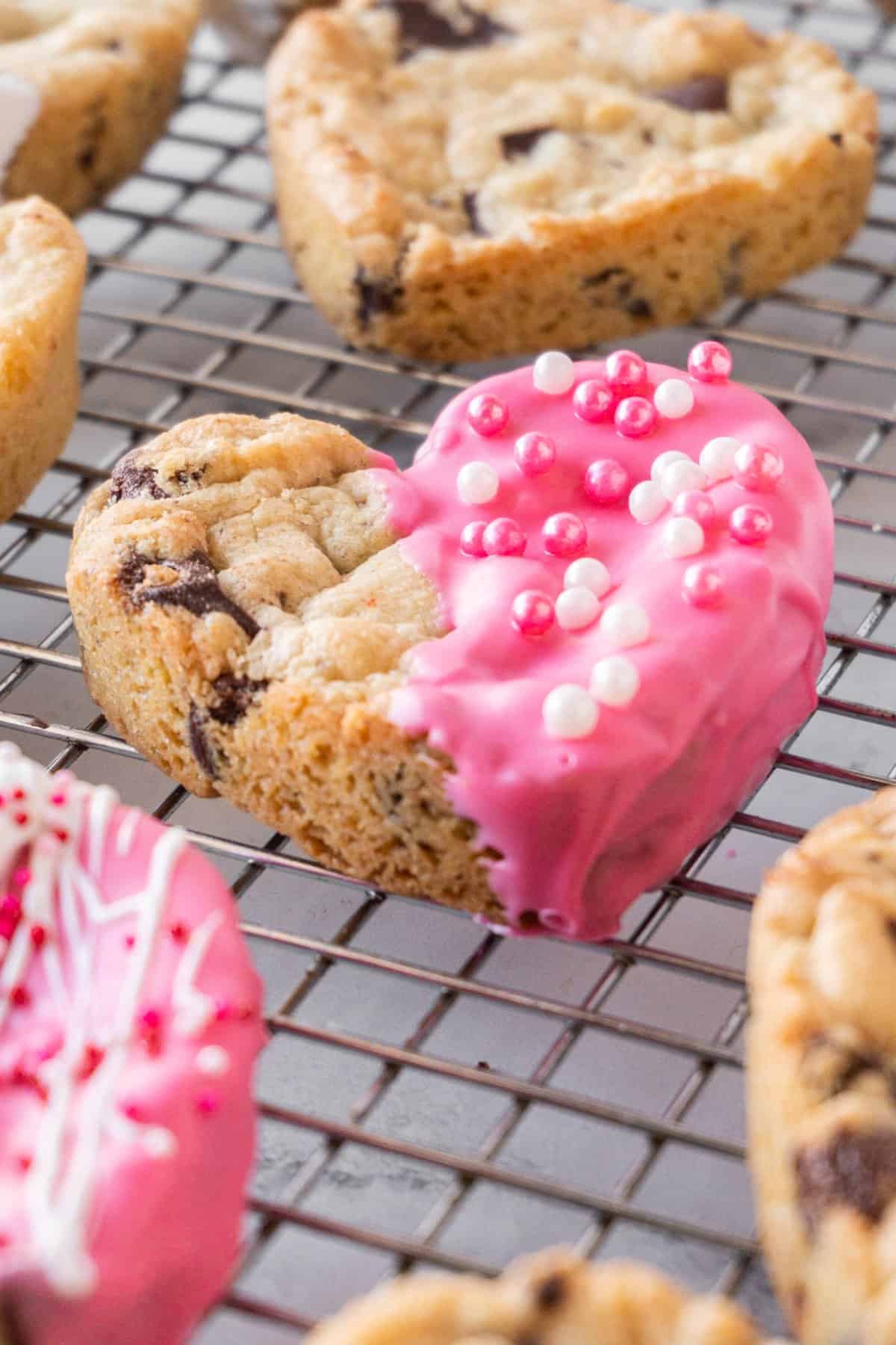 Chocolate chip cookie with pink frosting.