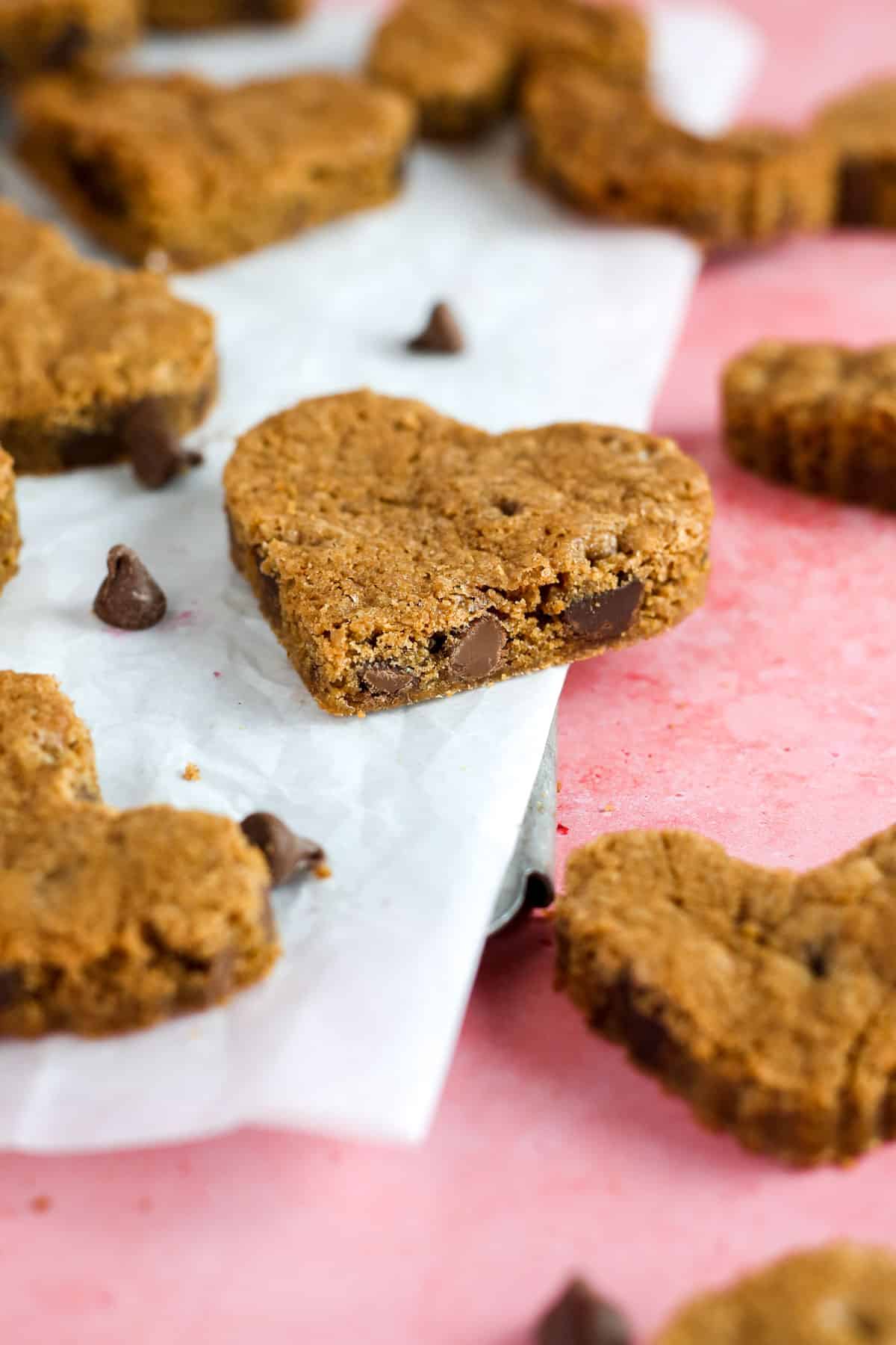 Chocolate heart cookies on a pink table.