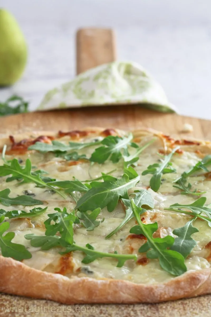 A close up of a whole pizza.