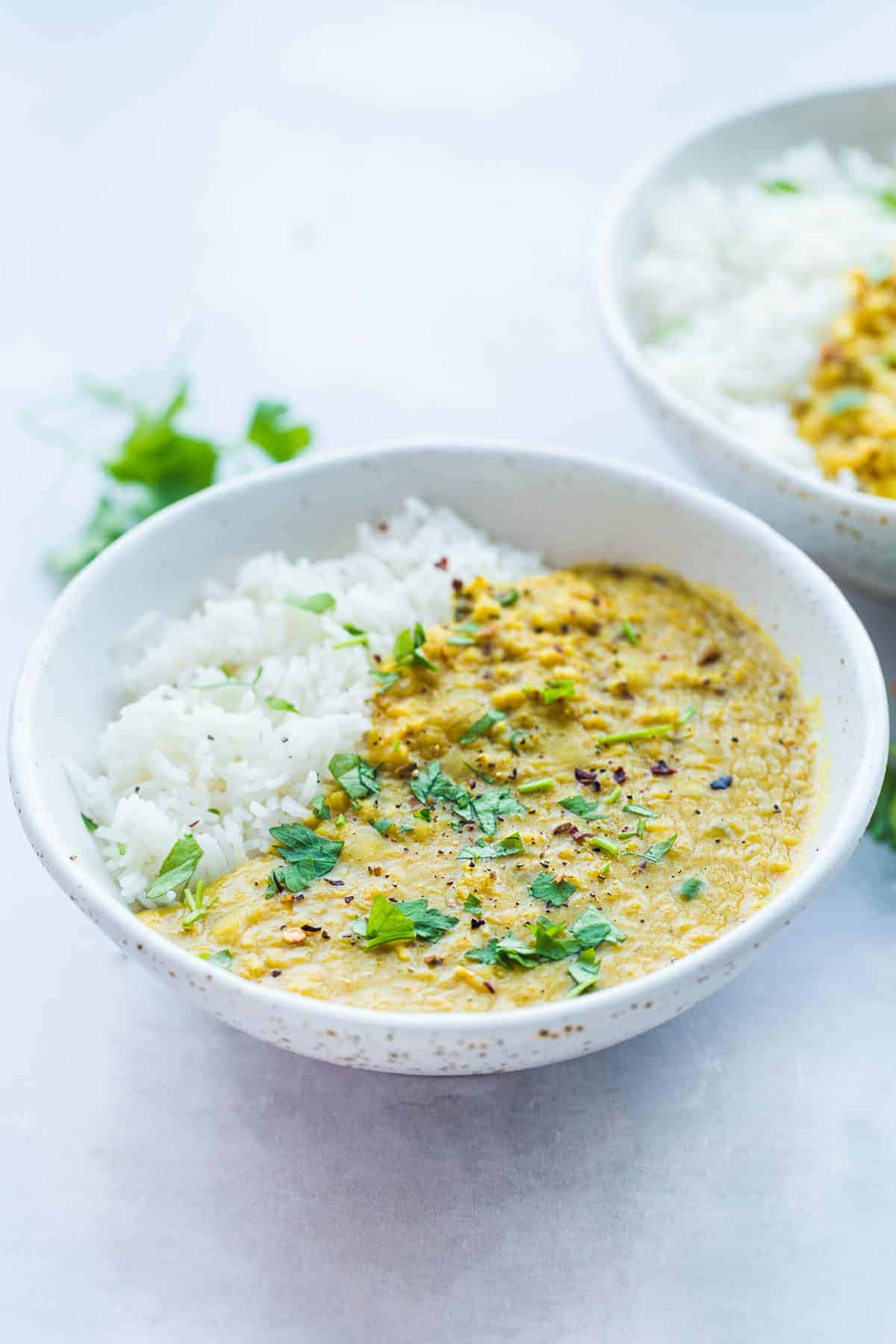 Lentil dahl in a white bowl with rice.