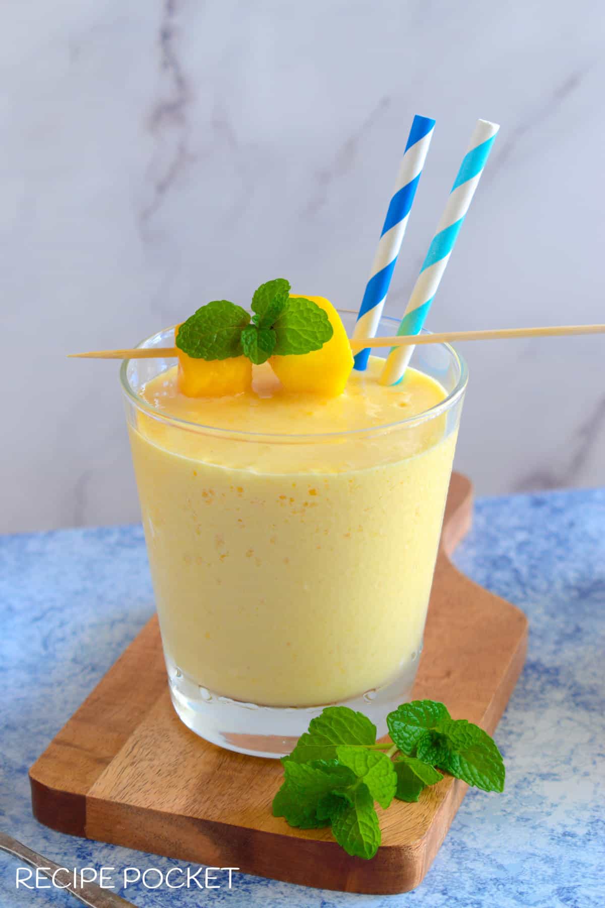 A close up of a milkshake on a blue table.