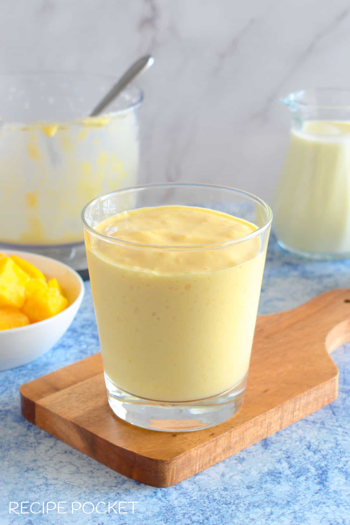 Mango milk shake in a glass before being garnished.