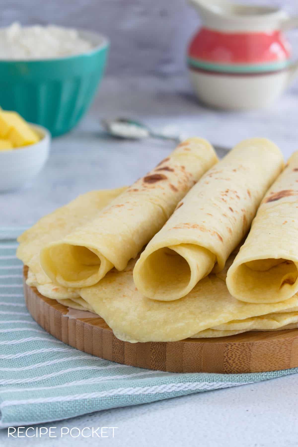 Three soft flour tortillas rolled to show how soft and pliable they are.
