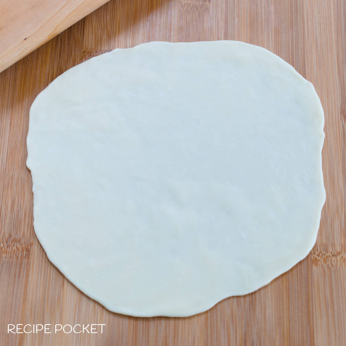 Dough rolled into a large circle.