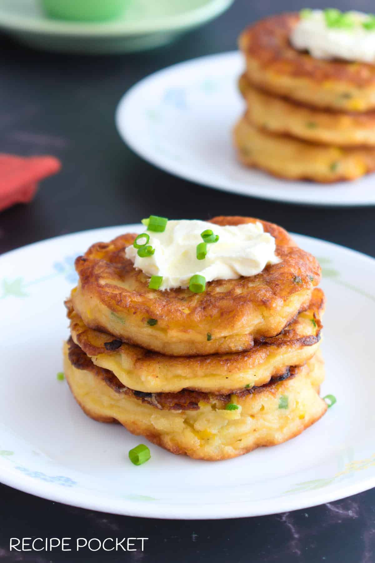 Homemade creamed corn fritters on a white plate.