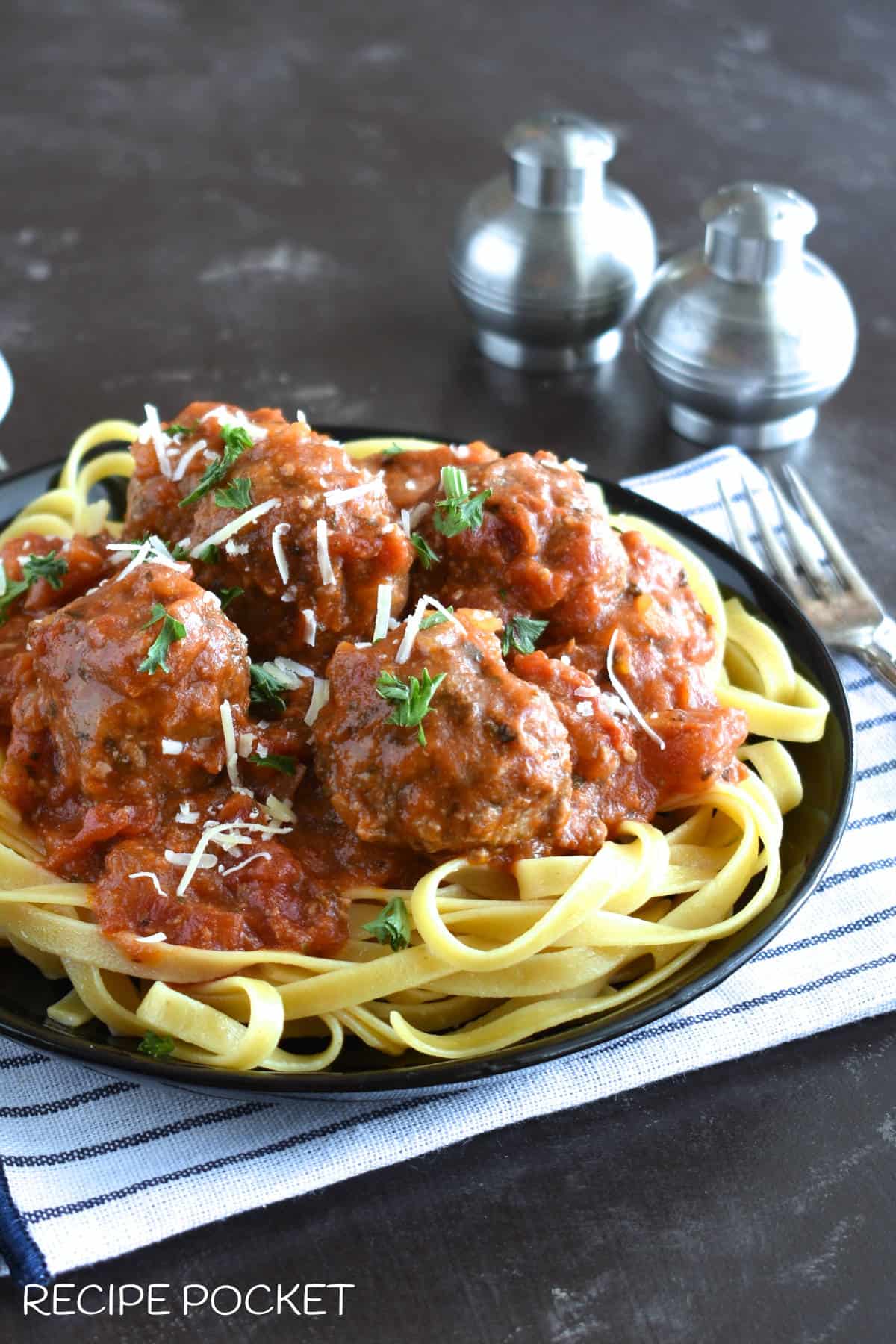 Meatballs in tomato suace on pasta.